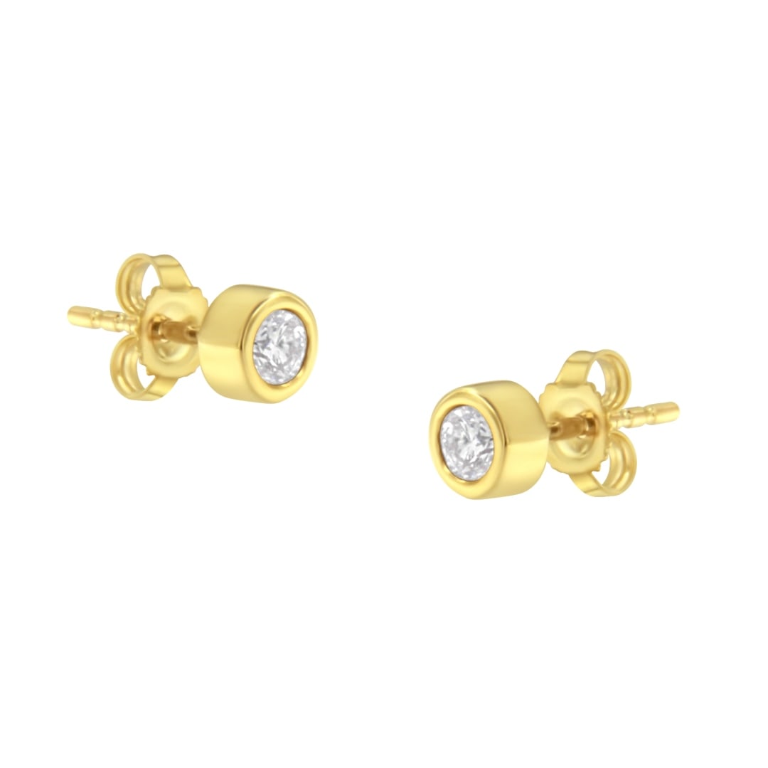 10k Gold .25ct Diamond Bezel-set Earrings: A stunning pair of earrings adorned with two genuine round-cut diamonds. These diamonds have a total weight of 0. 25 carats and are beautifully set in a bezel setting, creating a sleek and modern disp