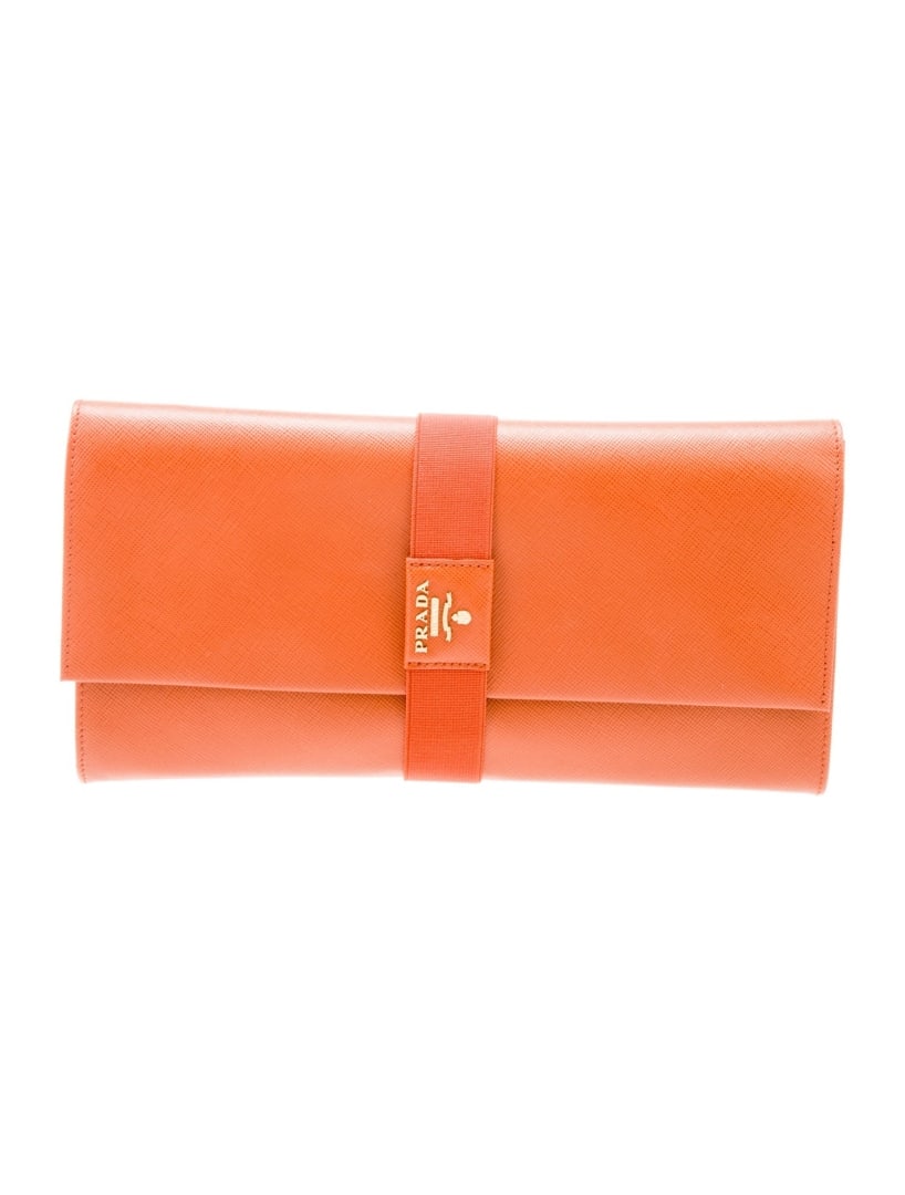 Prada Metal Papaya Saffiano Metal Leather Clutch: Condition is: good, pre-owned. Details: papaya saffiano metal leather, gold-tone hardware, nylon lining & single interior pocket, flap closure at front, includes box & authenticity card, height: 5", w