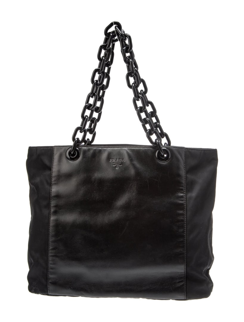 Prada Black Leather Tonal Hardware Top Handle Bag: Condition is: good, pre-owned. Details: by miuccia prada, black leather, tonal hardware, chain-link handles, nylon lining & dual interior pockets, open top, shoulder strap drop: 7", handle drop: 7", h