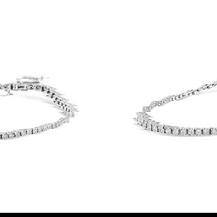 14k Gold Round 1.01ct Diamond Tennis Bracelet: Bracelet length: 7". This exquisite 1. 01 carats diamond bracelet is meticulously crafted in rhodium-plated solid 14k white gold. This stunning bracelet features 69 round cut lab-grown diamonds, secur