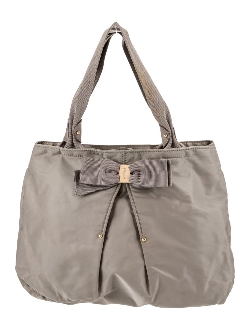 Salvatore Ferragamo Grey Nylon Bow Snap Tote: Condition is: good, pre-owned. Details: grey nylon, silver-tone hardware, rolled handles, bow accents, grosgrain lining & four interior pockets, snap closure at top, handle drop: 6. 5", height: 10. 75