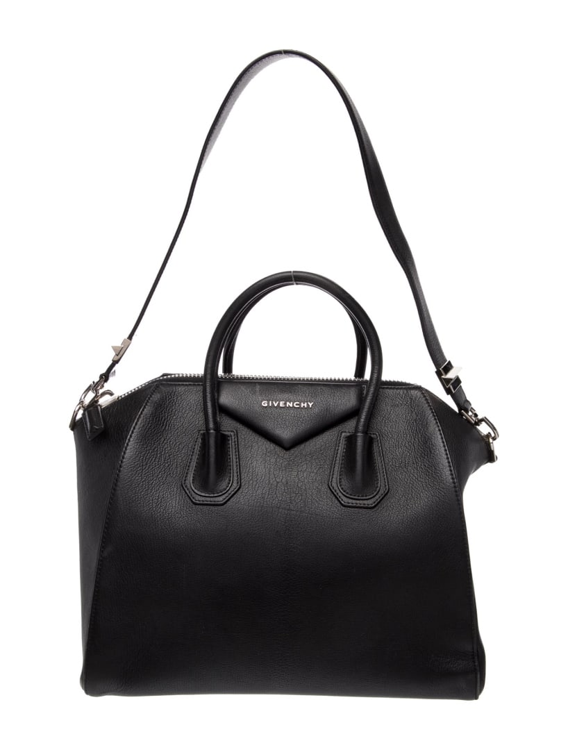 Givenchy Antigona Leather Zip Top Handle Bag: Condition is good, pre-owned. Details: black leather, silver-tone hardware, rolled handles & single shoulder strap, canvas lining & three interior pockets, zip closure at top, protective feet at base,