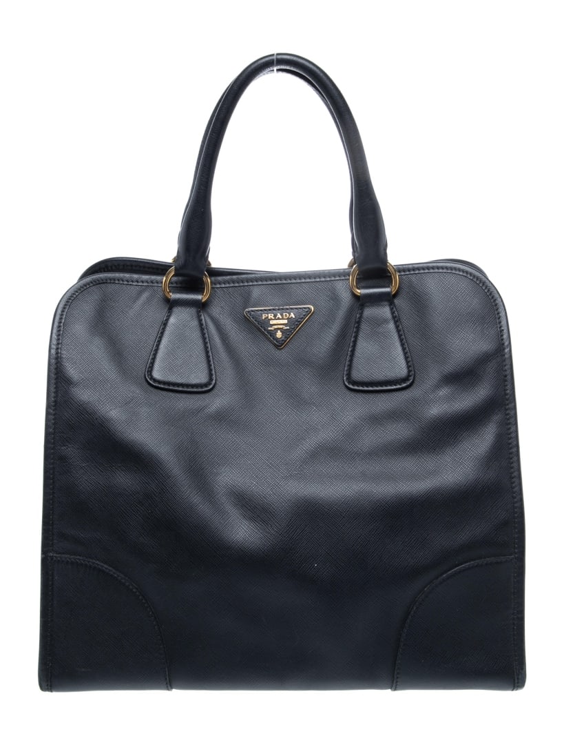 Prada Nero Saffiano Lux Leather Zip Top Hdl Bag: Condition is good, pre-owned. Details: nero saffiano lux leather, signature logo & saffiano leather, gold-tone hardware, rolled handles & single adjustable shoulder strap, leather trim embellishment,