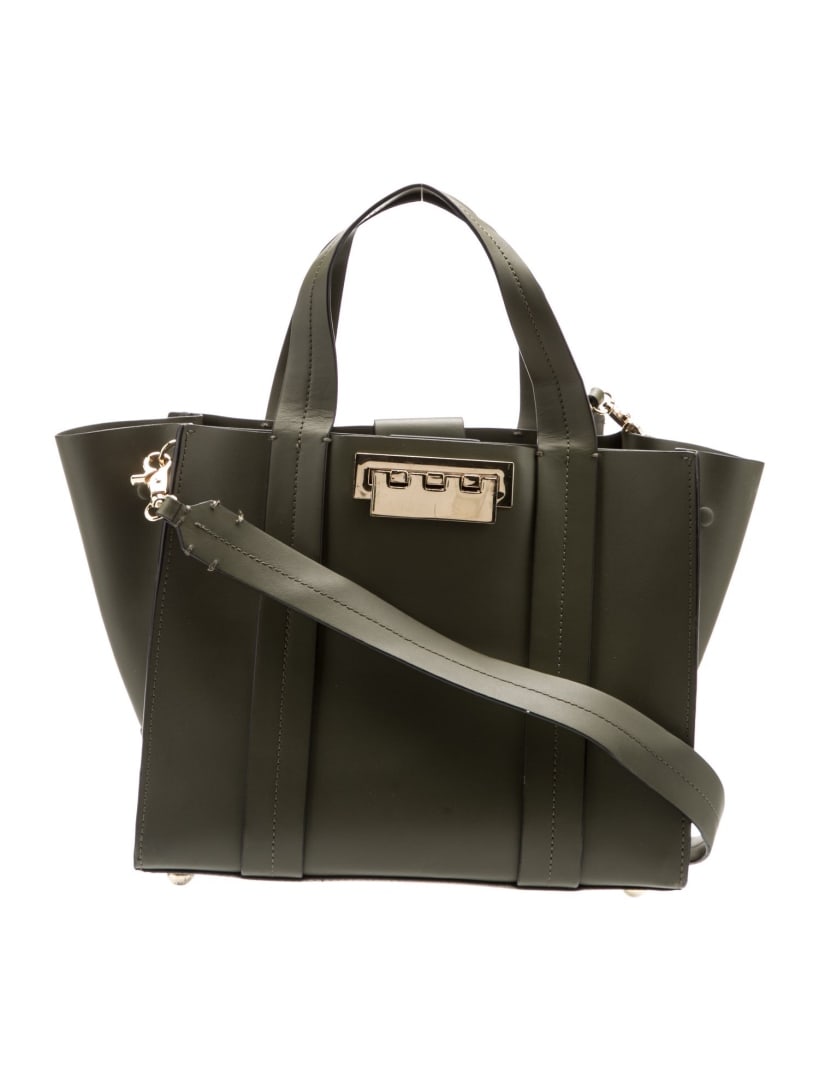Zac Posen Green Leather Fold-in Top Hdl Bag: Condition is good, pre-owned. Details: green leather, gold-tone hardware, flat handles & single shoulder strap, leather lining & dual interior pockets, fold-in flap closure at front, protective feet a