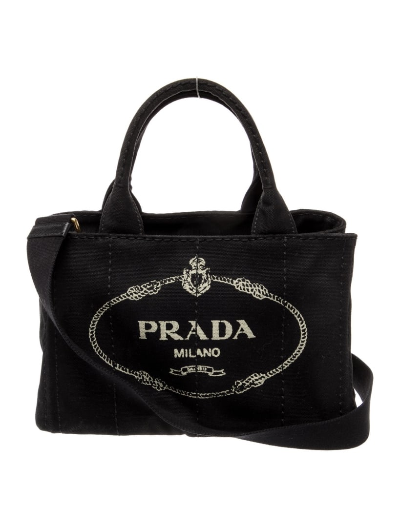 Prada Canapa Nero Canvas Small Shoulder Bag: Condition is very good, pre-owned. Details: nero canvas, graphic print, enameled metal triangle, gold-tone hardware, rolled handles & single adjustable shoulder strap, canvas lining & four interior po