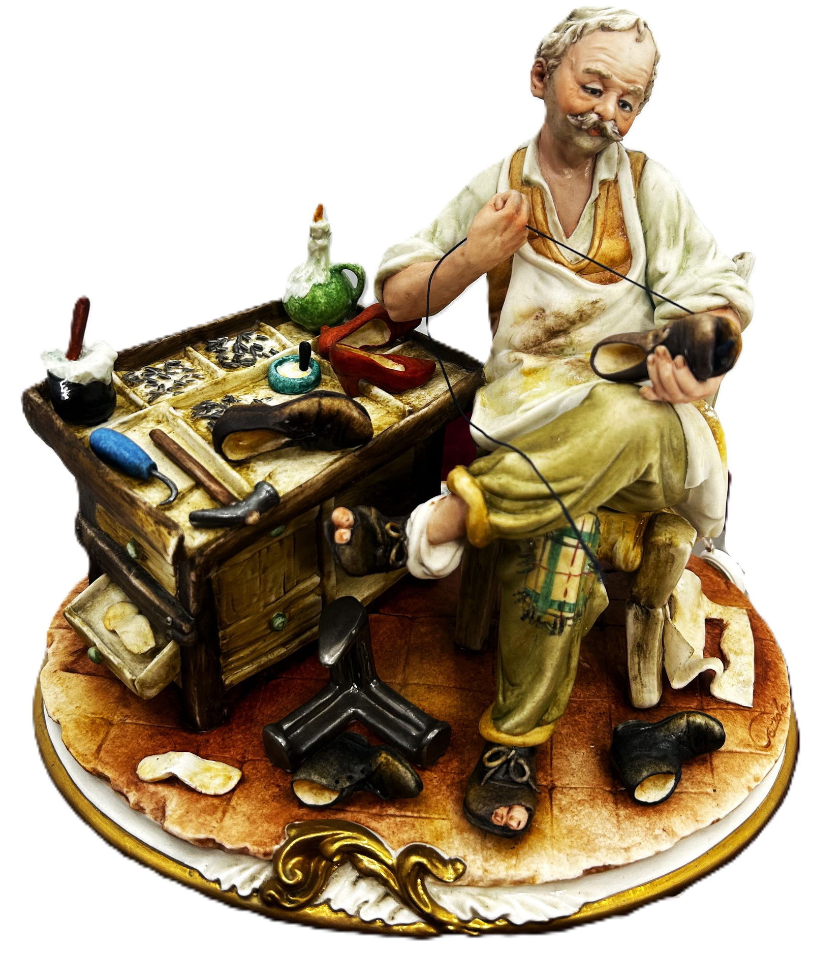 The Cobbler's Craft: An Italian capodimonte sculpture. The Cobbler's Craft exquisitely captures the skill and patience of a traditional shoe cobbler at work