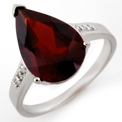 ACA Certified 5.10ctw Diamond & Garnet Ring White Gold: Lot no.: 1800 GENUINE 5.10 ctw DIAMOND & GARNET LADIES RING IN 10K WHITE GOLDGEMSTONE: 1 PEAR CUT GARNET 5.00 ctwDIAMOND: 6 ROUND CUT 0.10 ctwCLARITY: SI3-I2COLOR: H-KGOLD WEIGHT: APPROXIMATELY 2.70 G