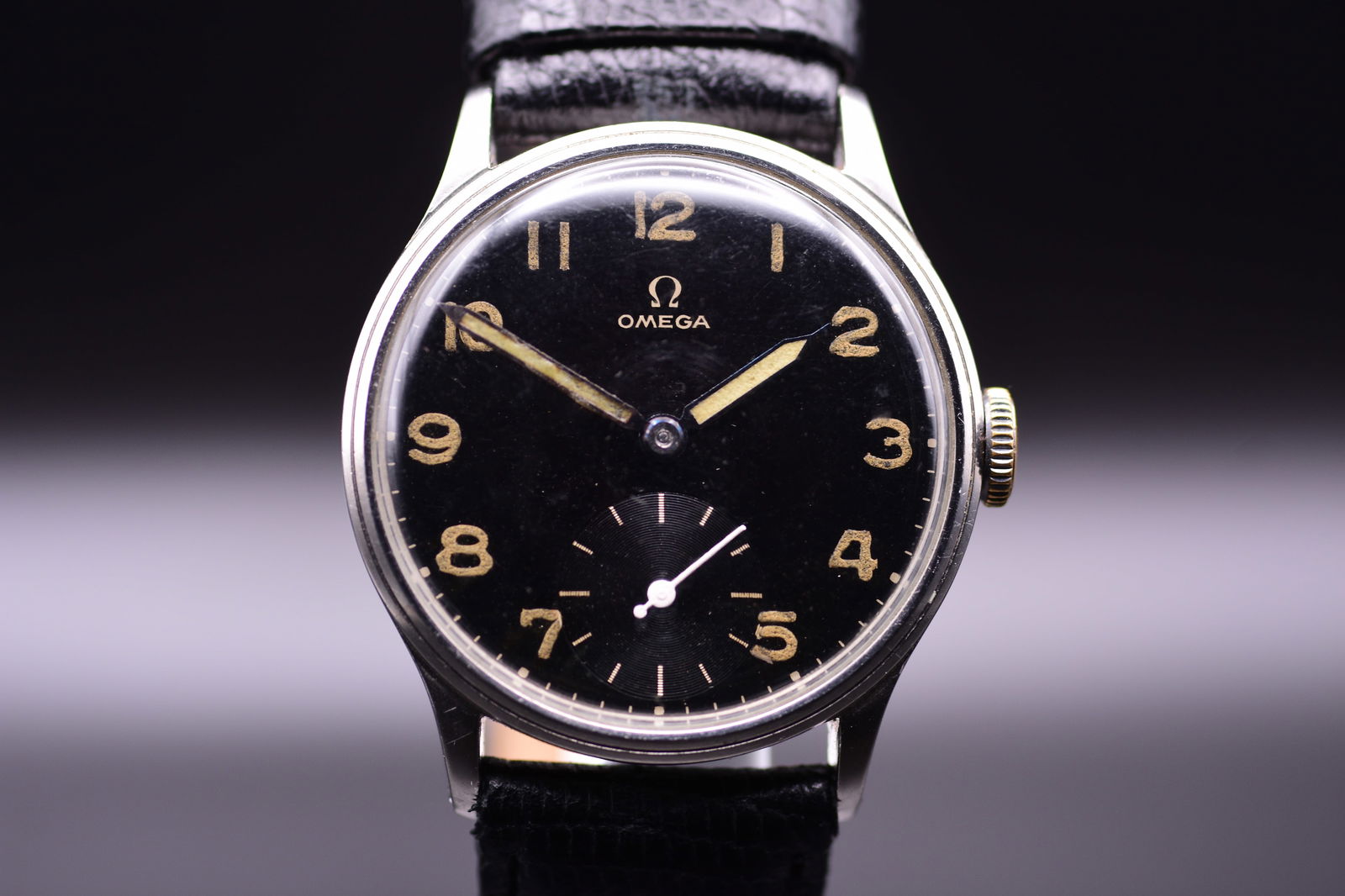 Omega Military Black Gilt Radium Dial Men's Wristwatch C.1939: Omega Military Black Gilt Radium Dial Men's Wristwatch C.1939 An exceptional piece of early World War II history, this 1939 Omega military watch is a fine example of the British Ministry of Defence's