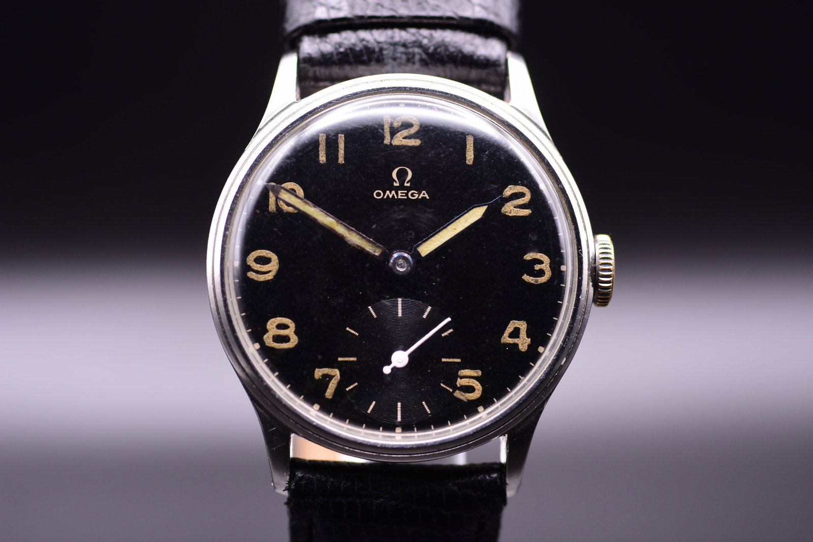 Omega Military Black Gilt Radium Dial Men's Wristwatch C.1939: Omega Military Black Gilt Radium Dial Men's Wristwatch C.1939 An exceptional piece of early World War II history, this 1939 Omega military watch is a fine example of the British Ministry of Defence's 