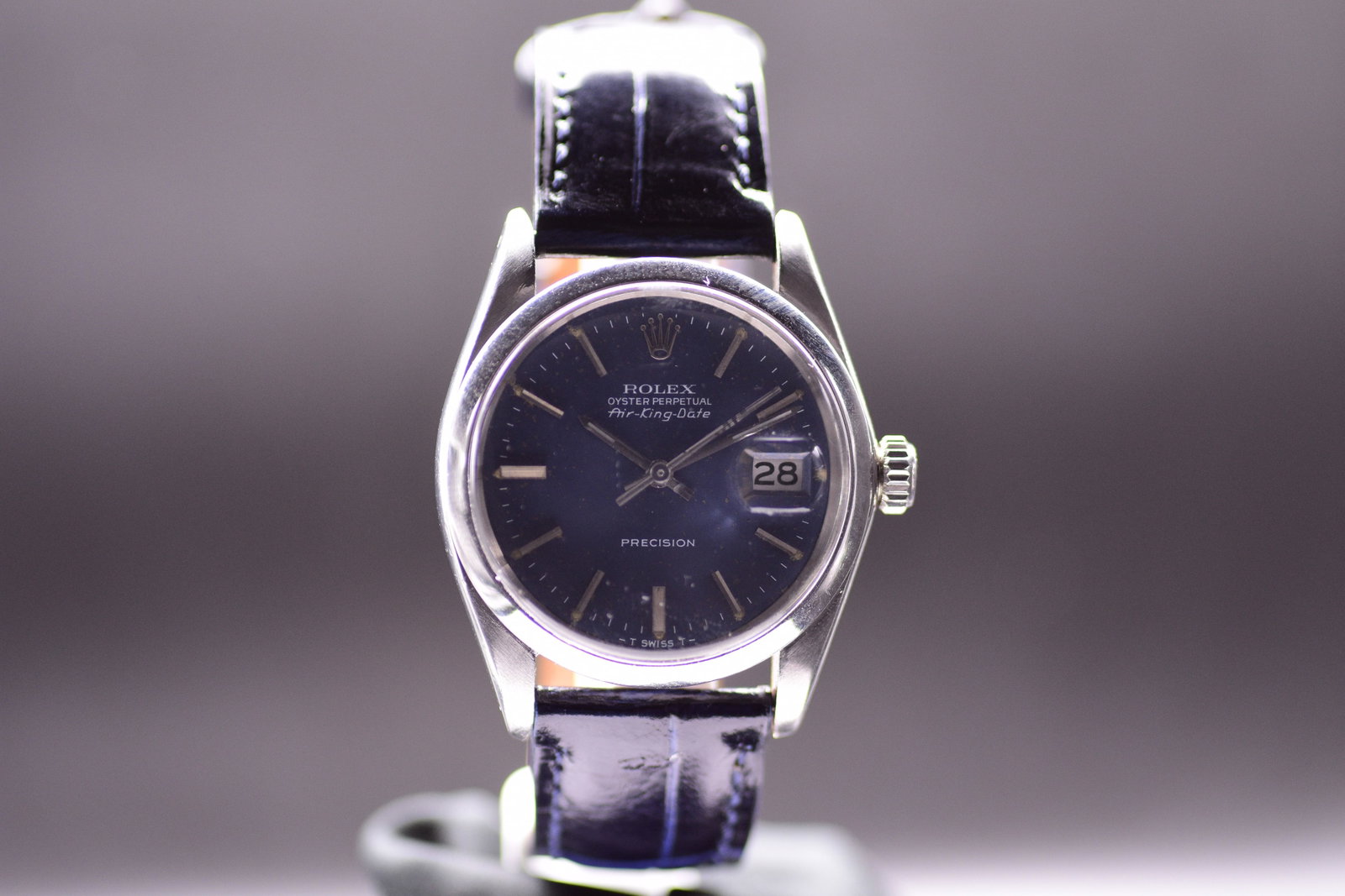 Rolex Air King Date Reference 5700 with Rare Blue Dial 1970's: A striking vintage Rolex defined by functional elegance. Built within a robust Oyster case, it stands out with a highly collectible, rich ink blue dial configuration. Featuring sharp baton markers and