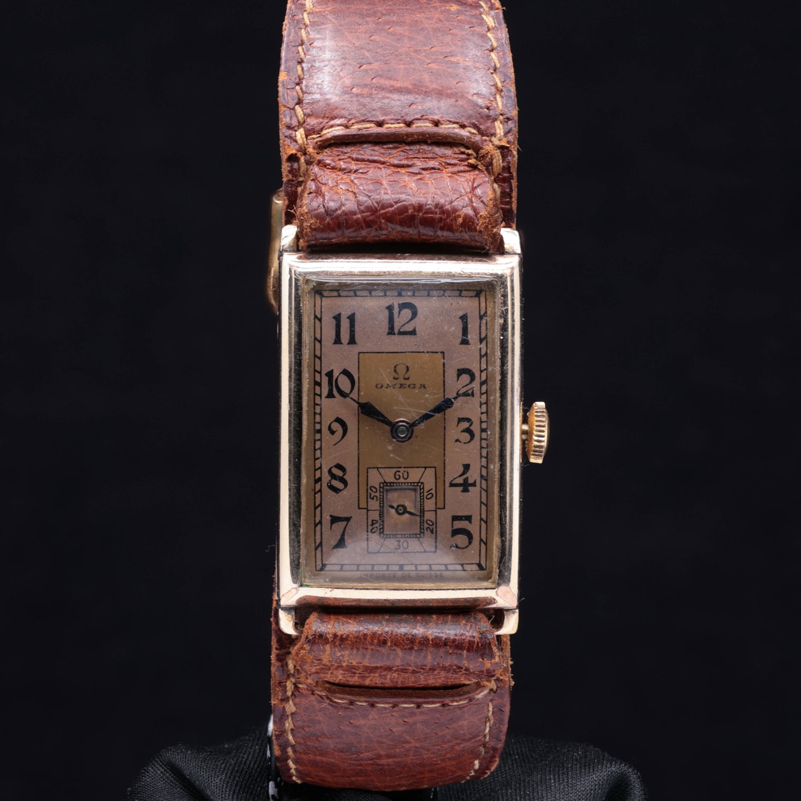 Omega Art Deco Rectangular T17 Gold Plated 1939: Title: Omega Art Deco Rectangular T17 Circa 1939 Catalogue Description: A classic gentleman’s vintage Art Deco rectangular mechanical wristwatch. The two tone golden dial features bold black explode