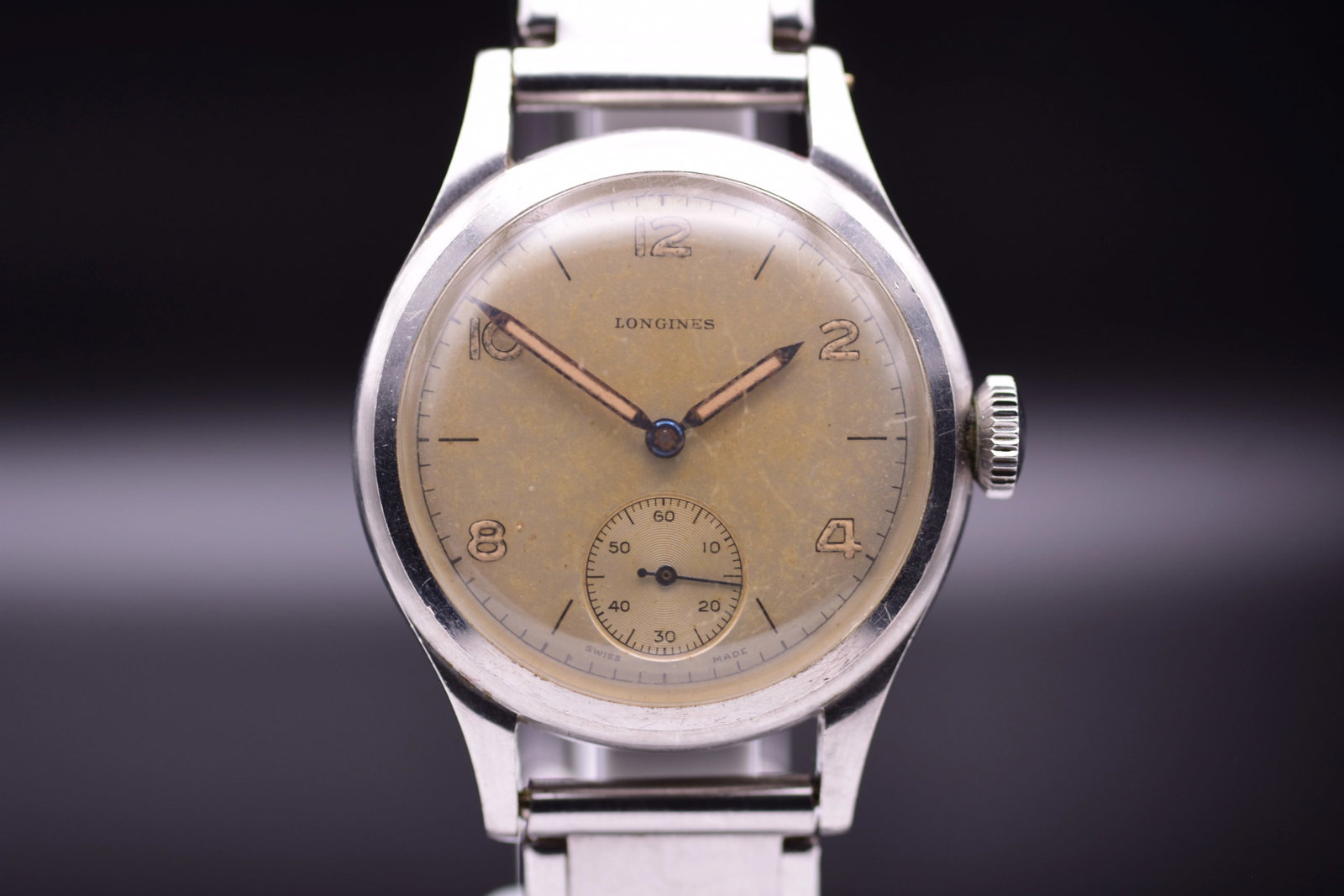 Longines Calatrava Style Dress Watch Champagne Patinated Dial Coin Edge Case 1940: Title: Longines Calatrava Style Dress Watch Champagne Patinated Dial Coin Edge Case 1940 Catalogue Description: A vintage stainless steel manual wind dress wristwatch circa 1940. Features a coin edge 