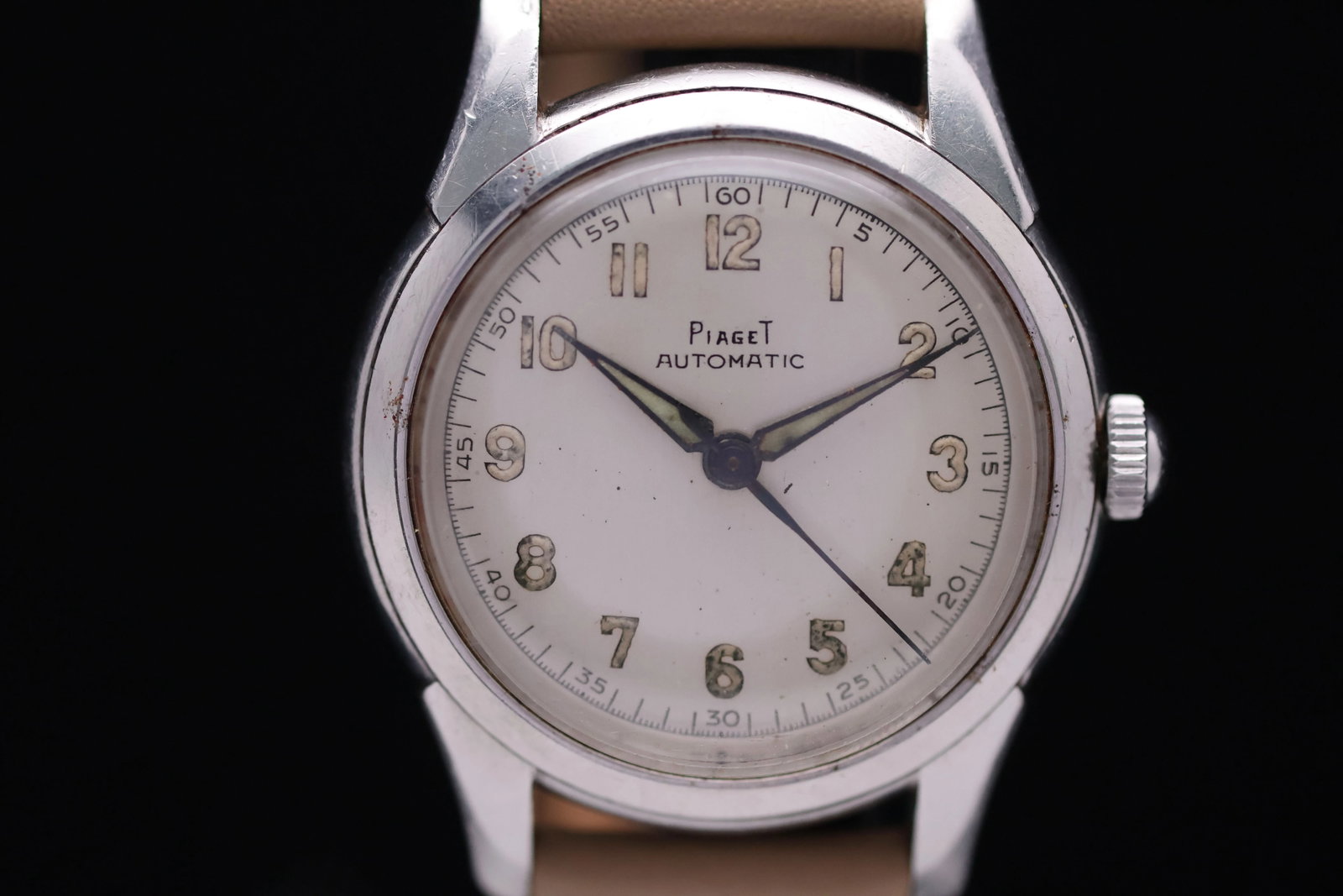 Piaget Automatic Breguet Numerals 4668 Circa 1950s Stainless Steel Silver Dial Patina Luminous Hands: Title: Piaget Automatic Breguet Numerals 4668 Circa 1950s Stainless Steel Silver Dial Patina Luminous Hands Catalogue Description: An automatic stainless steel wristwatch. The matte silver dial displa