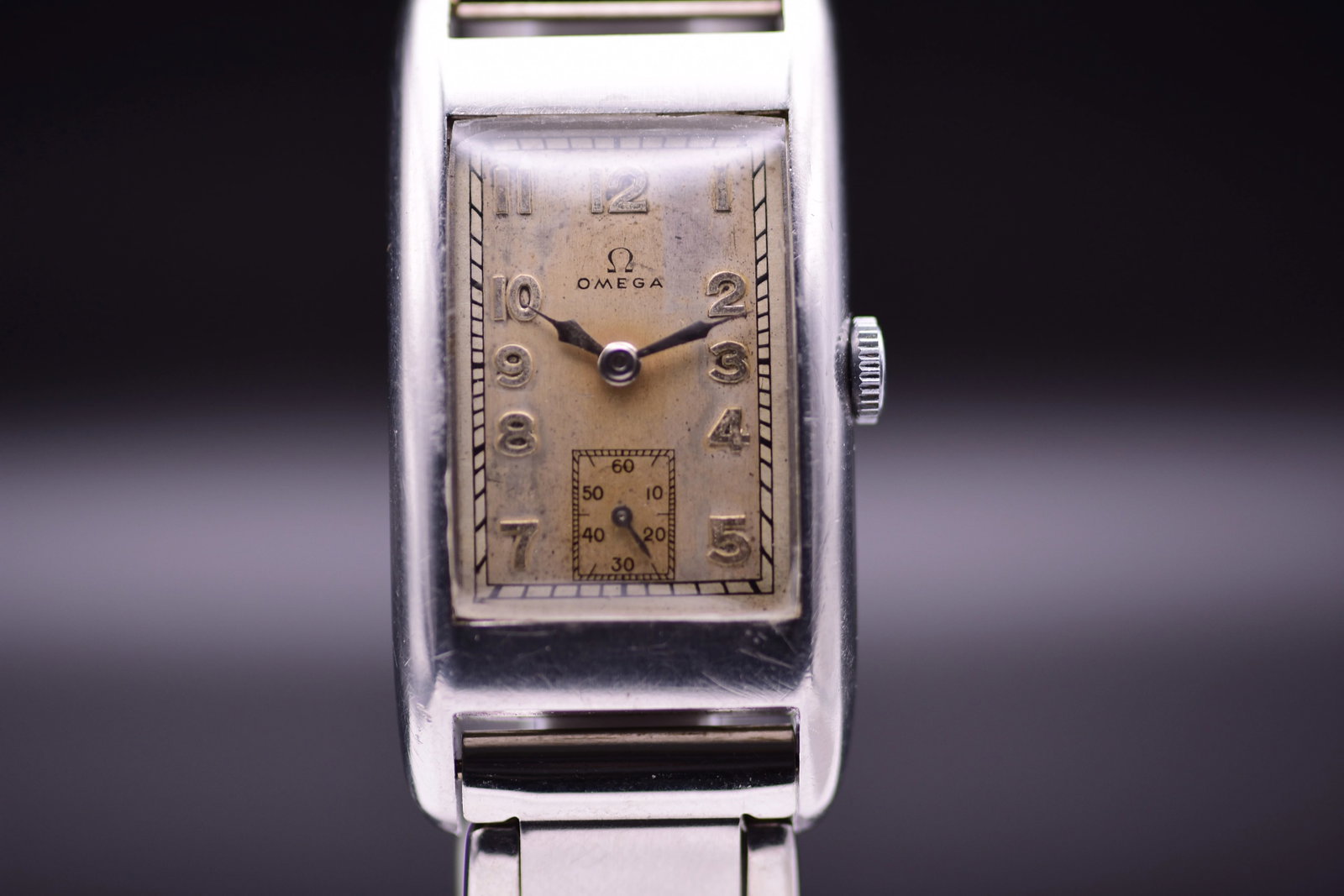 Omega Art Deco Tank T17 1936 Two Tone Sector Dial: Title: Omega Art Deco Tank T17 1936 Two Tone Sector Dial Catalogue Description: A manual wind stainless steel rectangular Art Deco Tank wristwatch. The silvered two tone sector dial displays an authen