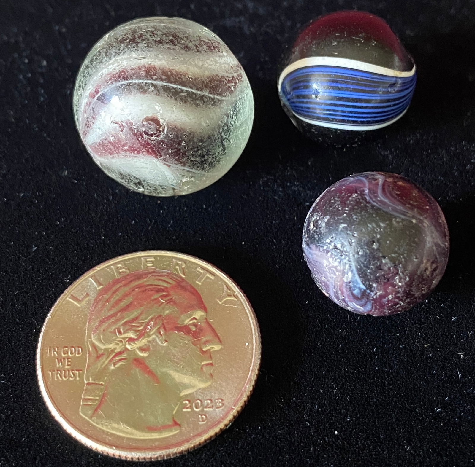 Three Older Glass Marbles - Solid Black with Blue/White Panels, Larger Clear with Solid Core, and (1 of 6)