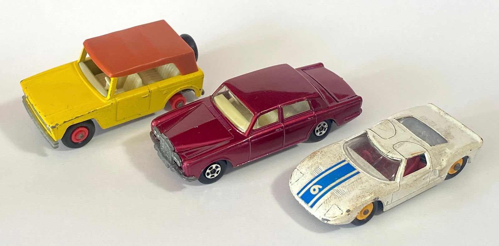 Three Lesney Matchbox Series Toy Cars - Ford GT, Rolls Royce Silver Shadow, and Field Car (Missing: Three Lesney Matchbox Series Toy Cars - Ford GT, Rolls Royce Silver Shadow, and Field Car (Missing One Tire)