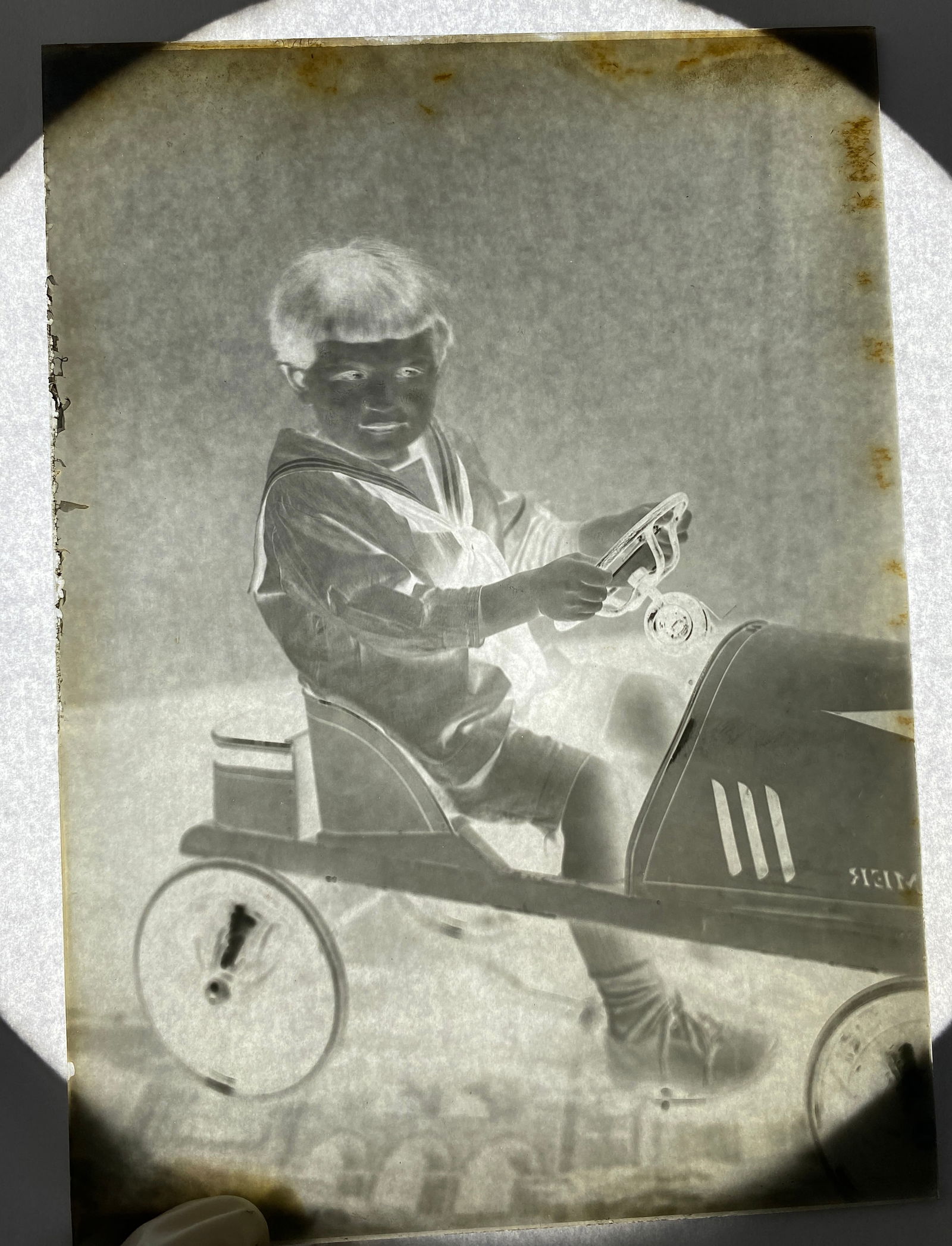 Glass Negative of Child Playing in a Roamer Pedal Car: Glass Negative of Child Playing in a Roamer Pedal Car