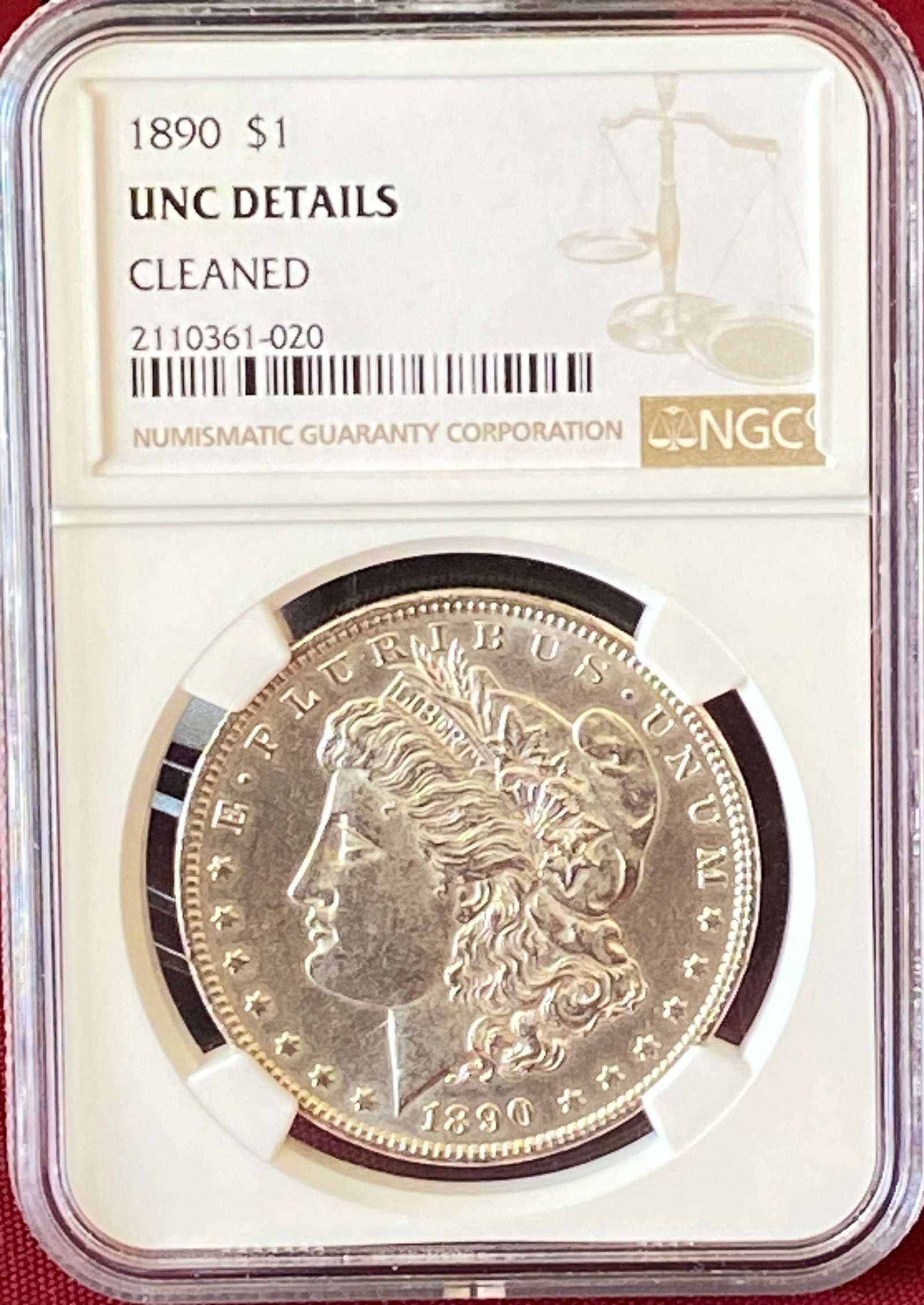 Graded 1890 Morgan Silver Dollar - Cleaned - Uncirculated Details by NGC: Graded 1890 Morgan Silver Dollar - Cleaned - Uncirculated Details by NGC