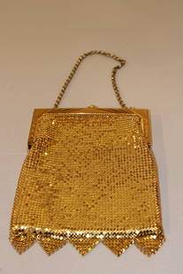 Vintage Whiting & David Gold Mesh Purse: A vintage Whiting & Davis gold mesh purse is a timeless and elegant accessory, known for its shimmering metal mesh design and sophisticated craftsmanship. These purses often feature a kiss-lock closur