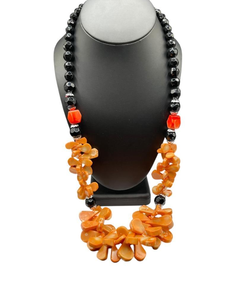 PINK CORAL BEAD FASHION NECKLACE: FEATURING TEAR DROP SHAPED GRADUATING PINK CORAL ACCENTED BY BLACK FACETED BEADS 28", UP TO 1 1/8" CORAL
