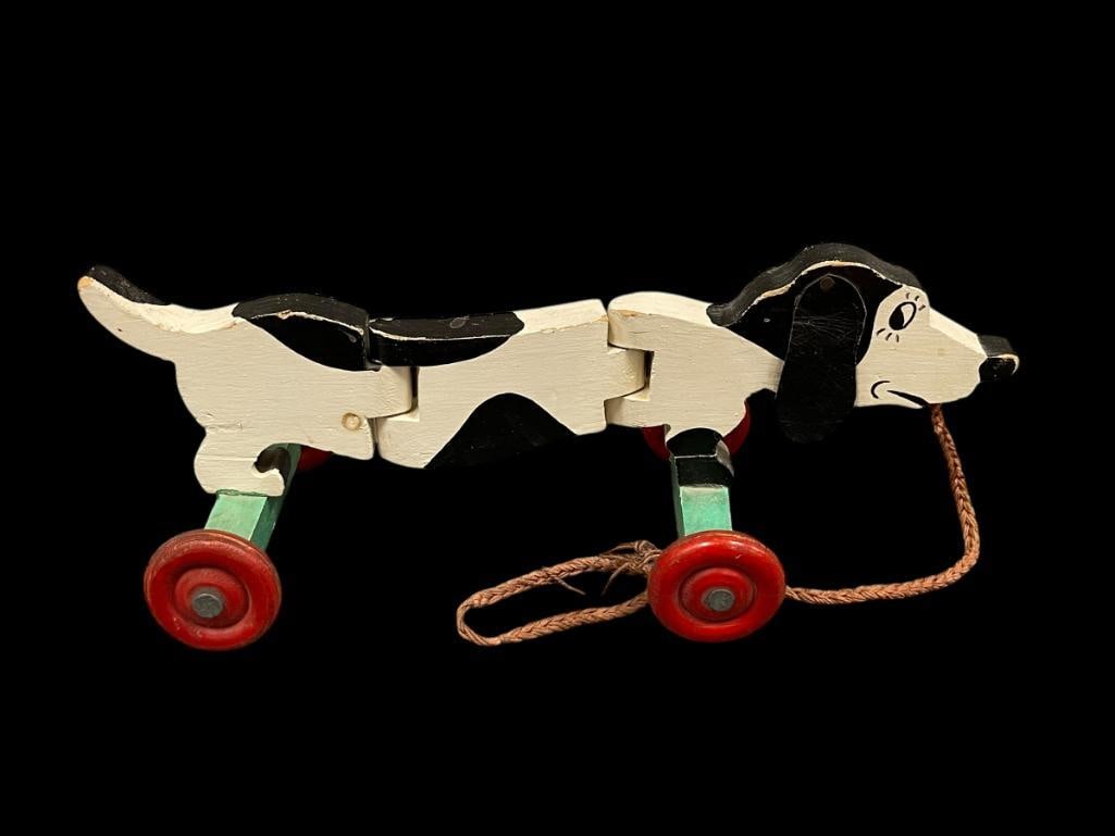 VINTAGE CHILDRENS WOODEN WALKING DOG PULL TOY: WOODEN WHEELS WITH SWIVEL BODY, COMPLETE SHOWS AGE AND WEAR, OVERALL GOOD CONDITION 14 1/2" L