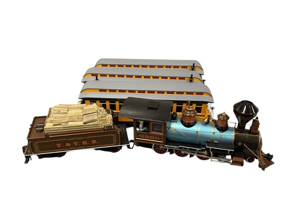 BACHMANN BIG HAULER "G" SCALE MODEL TRAIN SET #26 VIRGINIA & TRUCKEE STEAM LOCOMOTIVE: 4-6-0 LOCOMOTIVE WITH TENDER AND THREE PASSENGER CARS IN CLASSIC YELLOW AND GREEN COLOR WAY, WITH LIGHT AND STEAM FUNCTION, IN MINT CONDITION DOES NOT APPEAR TO HAVE BEEN USED, NO TRACK LOCOMOTIVE MEA