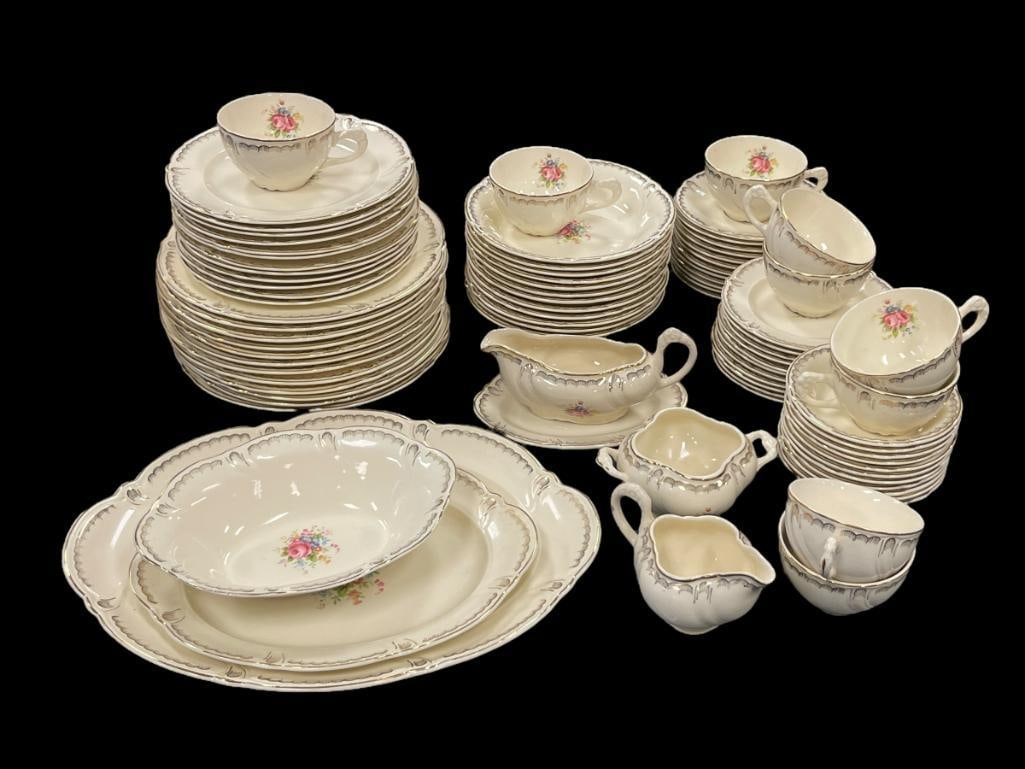 TAYLOR SMITH TAYLOR US POTTERY IVORY CHINA SET FLORAL AND GILT DESIGN: SEVEN PIECE SETTING FOR 9+ WITH EXTRA PIECES AND SERVING PIECES INCLUDING SERVING PLATTERS, SERVING BOWL, GRAVY BOAT, AND CREAMER AND SUGAR BOWL, FEW PLATES HAVE SMALL CHIPS ON THE EDGE