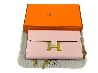 MARKED HERMES CONSTANCE PINK SLIM WALLET WITH GOLD "H" BUCKLE: POLISHED GOLD CHAIN LINK SHOULDER STRAP WITH BRUSHED AND POLISHED "H" BUCKLE, INCLUDES ORIGINAL BOX AND DUST COVER, NEW CONDITION, NOT AUTHENTICATED 8" X 4 3/4"