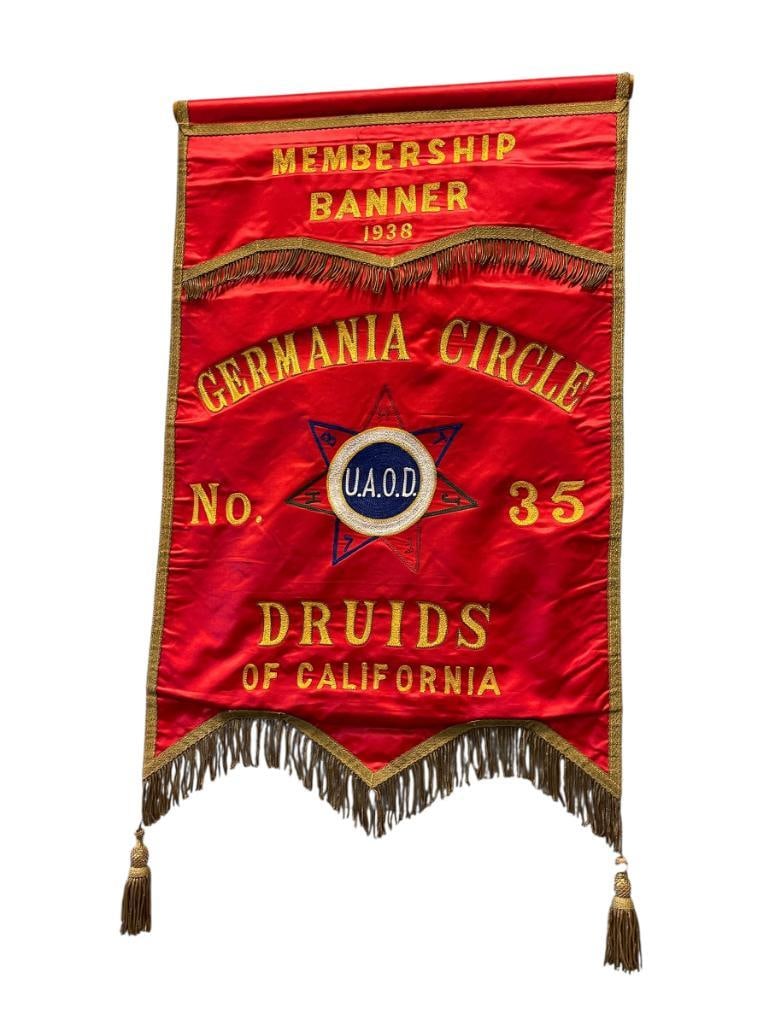 1938 GERMANIA CIRCLE NO. 35 UNITED ANCIENT ORDER OF DROIDS CLIFORNIA FRATERNITY BANNER: U.A.O.D. DATES BACK TO 1860 IN PLACERVILLE WHERE FIRST DRUID WAS ESTABLISHED BY FREDERICK SIEG A GERMAN IMMIGRANT, BANNER IS RED WITH NAVY BLUE BACK, GOLD TRIM AND FRINGE, EMBROIDERED LETTERING IN GOL