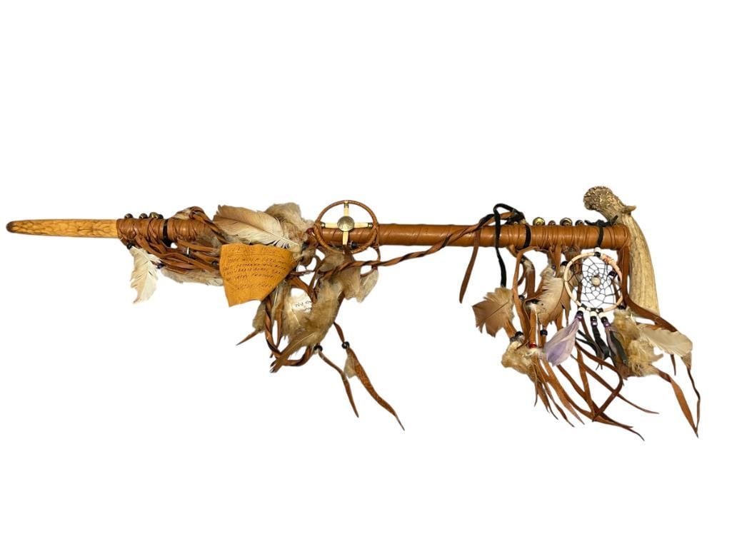 LATE 20TH CENTURY NATIVE AMERICAN PEACE PIPE, HAND CRAFTED: HAND CRAFTED NATIVE AMERICAN PEACE PIPE MADE FROM DEER ANTLER AND WOOD, DECORATED WITH BUFFALO NICKEL, GLASS AND BRASS BEADS, WRAPPED IN DEER SKIN WITH TURKEY FEATHERS 31" L