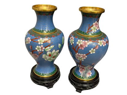 VINTAGE CHINESE PAIR OF CLOISONNE ENAMELED VASES TRADITIONAL DESIGN WITH WOOD CARVED BASES: PAIR OF CLOISONNE ENAMELED CHINESE VASES TRADITIONAL DESIGN, BUTTERFLIES AND CHERRY BLOSSOM, INCLUDES WOOD CARVED BASES 8 1/2" H WITH STAND