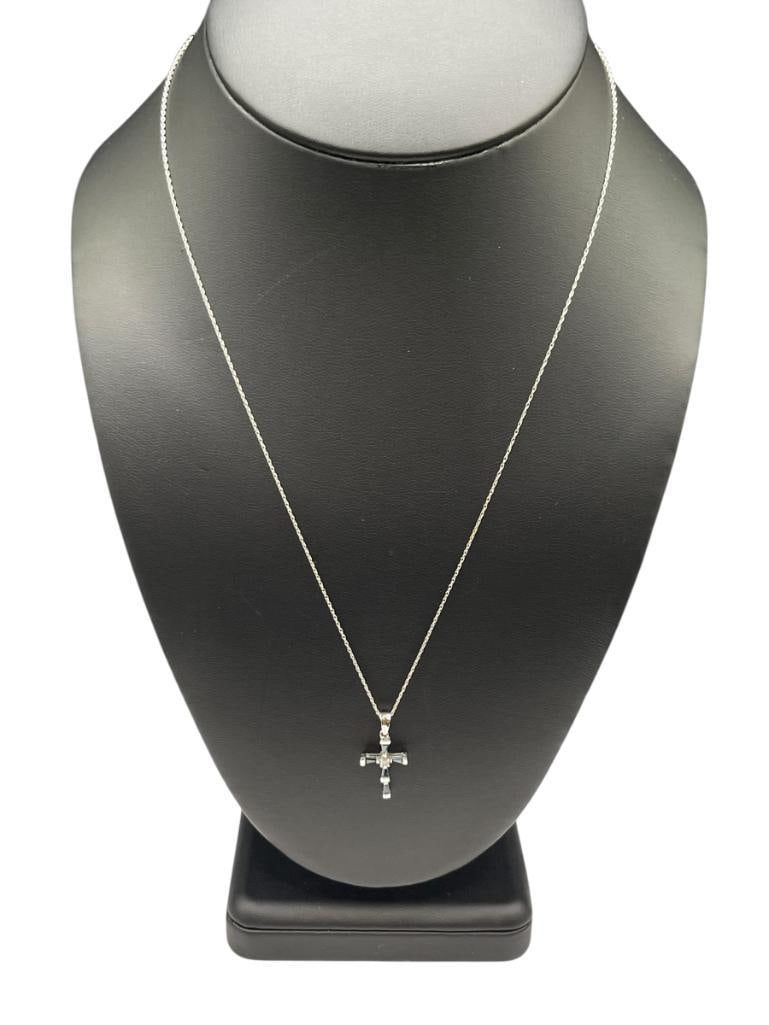 10K WHITE GOLD BLUE SPINEL AND DIAMOND CROSS PENDANT NECKLACE: FEATURING FOUR BLUE SPINELS AND A SINGLE ROUND BRILLIANT CUT DIAMOND IN CENTER, PENDANT IS HALLMARKED, 10K WHITE GOLD CHAIN NECKLACE 19" NECKLACE, 1" PENDANT, 1.33 GRAMS, .03CT DIAMOND 