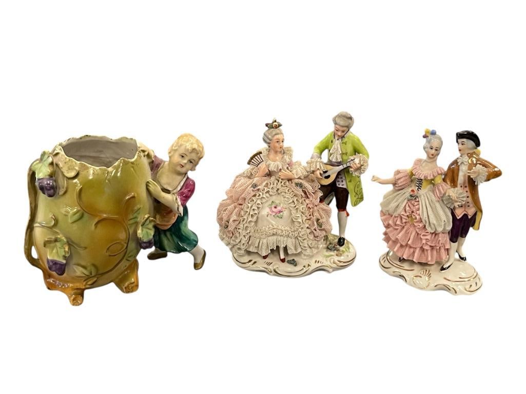 TWO ANTIQUE DRESDEN ROCOCO COUPLES PINK LACE AND ANTIQUE GERMAN BISQUE EGG VASE: DRESDEN PIECES HAVE DAMAGE TO SOME OF THE LACE, ONE LADY FINGER HAS A MINOR CHIP, BOTH ARE MARKED ON THE BOTTOM, THE EGG VASE IS IN OVERALL GOOD CONDITION AND UNMARKED 4 1/2" X 5" EGG VASE 