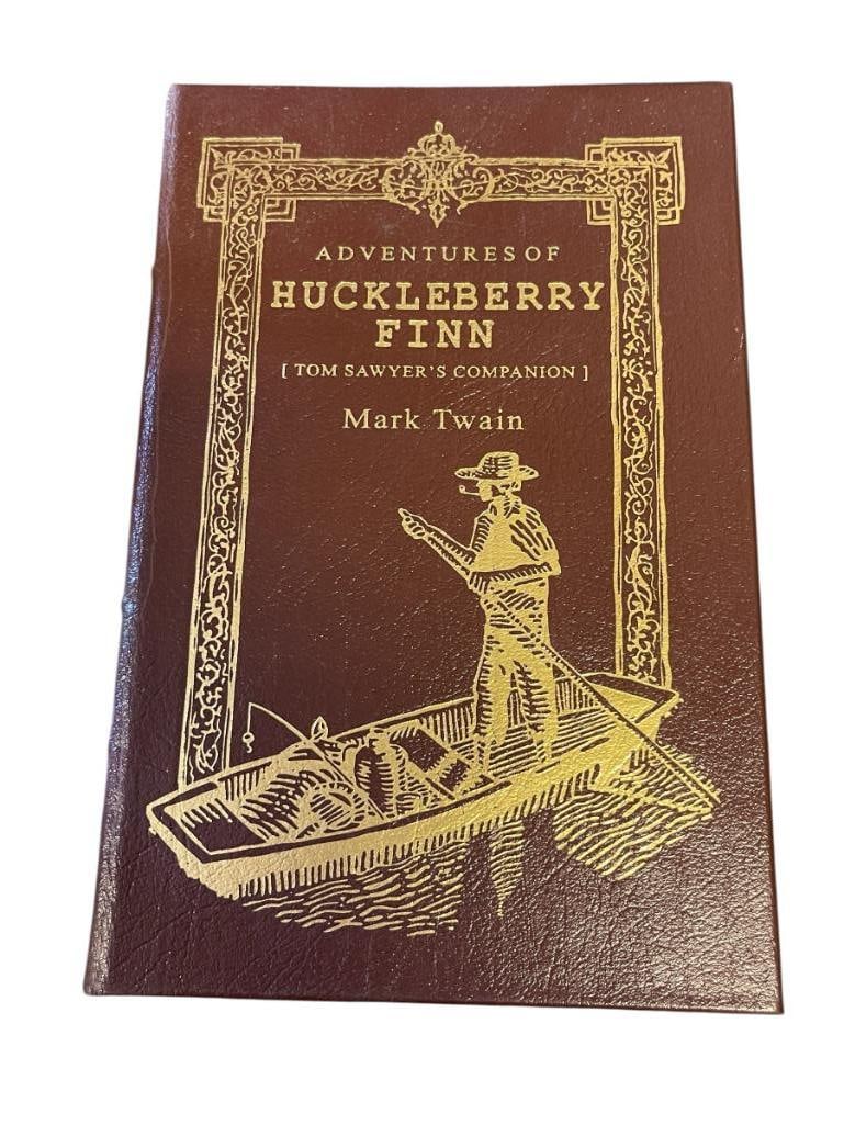 THE EASTON PRESS LEATHER BOUND BOOK THE ADVENRURES OF HUCKLEBERRY FINN BY MARK TWAIN: ILLUSTRATED BY THOMAS HART BENTON, COLLECTOR'S EDITION, BROWN LEATHER COVERS WITH GILT LETTERING AND ILLUSTRATIONS, GILT PAGE EDGES, NEAR MINT CONDITION 6 1/4" X 9 1/2"