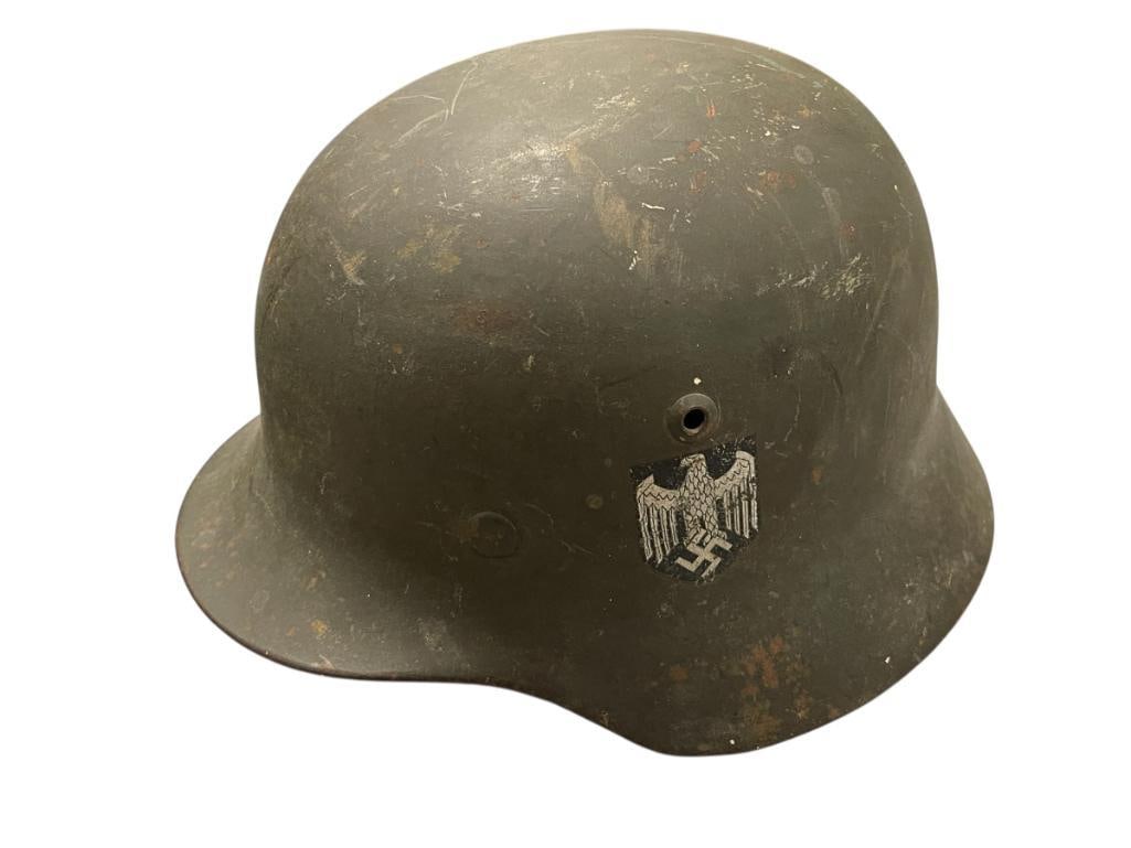 GERMAN WWII ARMY MILITARY HELMETWITH EAGLE AND SWATSIKA DECAL ONE SIDE: GREEN IN COLOR WITH PATINA, LEATHER LINER, NUMBERED 3570 ON THE INSIDE BACK EDGE 10 5/8" X 8 7/8"