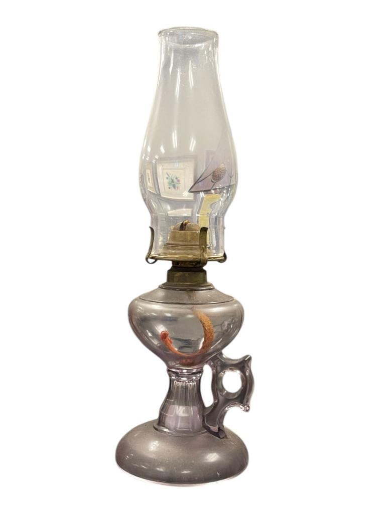 19TH CENTURY SUN-PURPLED KEROSEEN FINGER OIL LAMP WITH LA BASTIE CLEAR GLASS CHIMNEY: SUN-PURPLED OIL LAMP WITH DECORATIVE FINGER LOOP HANDLE, ROUND BASE 14 3/4" H