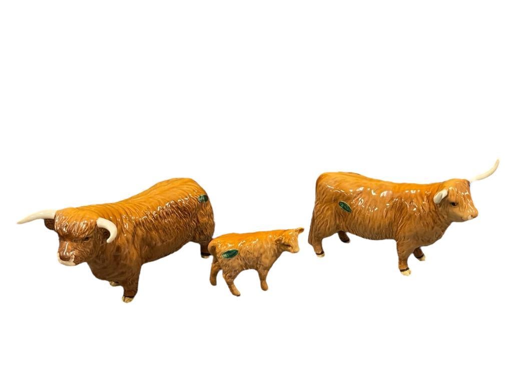 BESWICK ENGLISH POTTERY HIGHLAND BULL, COW, AND CALF CIRCA 1961-1990 DESIGNED BY ARTHUR GREDINGTON: RETIRED FIGURES, EACH IS MARKED ON THE BOTTOM WITH ORIGINAL LABEL, MADE IN ENGLAND, NO DAMAGE OR REPAIRS 4", 7 1/4", AND 8 1/8" L
