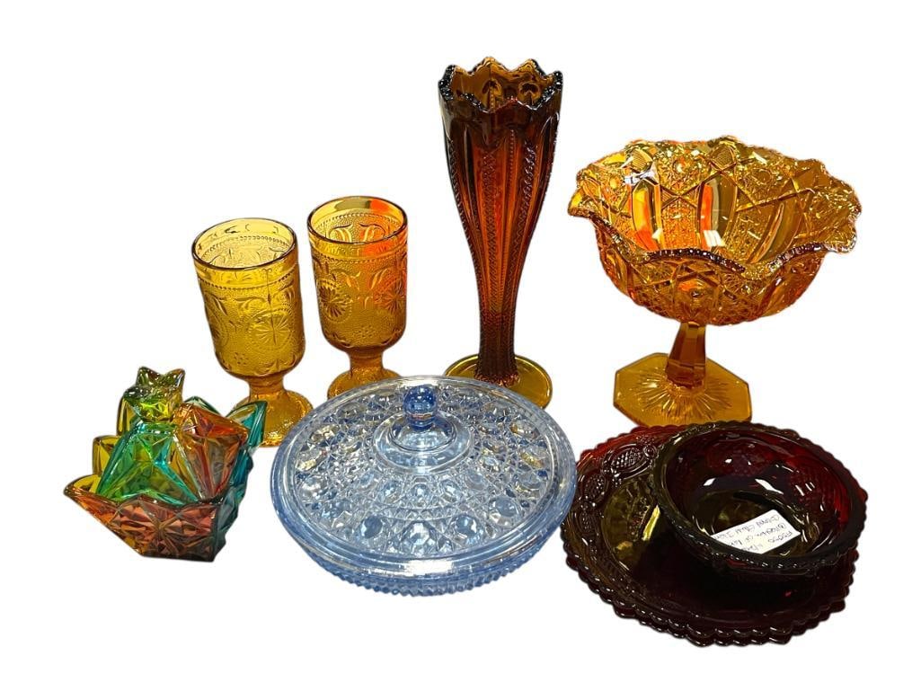 COLLECTION OF RETRO / VINTAGE COLORED GLASS INCLUDING SOME AMBER AND CRANBERRY: INCLUDES TWO CRANBERRY COLORED PLATES AND A SMALL BOWL, TWO COVERED CANDY DISHES, GOBLETS, FOOTED PEDESTAL BOWL AND VASE, NO CHIPS OR CRACKS LARGEST IS 10 1/4" H, BLUE DISH IS 7 1/2" DIAMETER