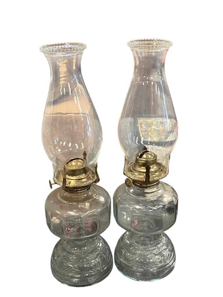 TWO VINTAGE MATCHING OIL LAMPS WITH CHIMNEYS: BOTH ARE CLEAR GLASS 14" X 4 1/2"