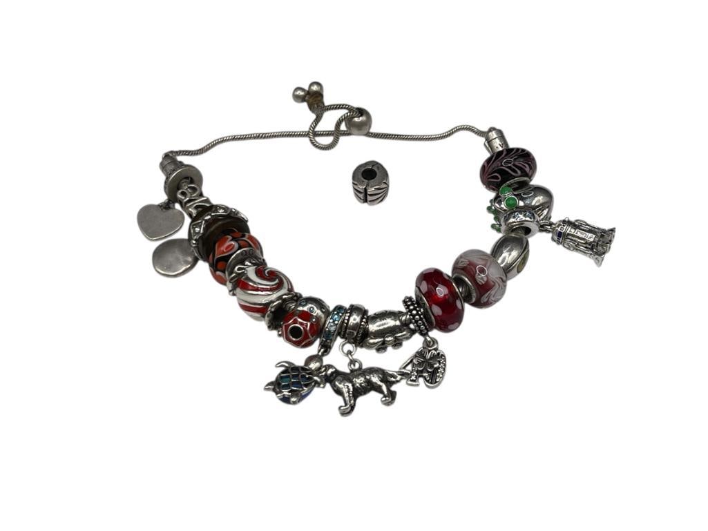 VINTAGE STERLING SILVER PANDORA BRACELET AND CHARMS: SOME CHARMS PANDORA AND OTHERS ARE NOT, MANY FEATURES STERLING SILVER CORES, TOGGLE ATTACHMENT FOR ADJUSTABLE LENGTH, ALSO INCLUDES CHARM TO MAKE INTO STANDARD PANDORA BRACELET ADJUSTABLE LENGTH, 65.9