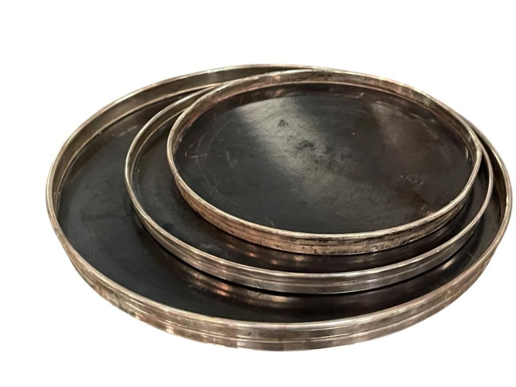 THREE GORHAM STERLING SILVER RIM TRIVET / TRAYS: THREE TRAYS / TRIVETS IN GRADUATING SIZE, TRIVETS DO SHOW WEAR, STERLING RIMS ALSO SHOW MINOR BENDS 6 3/8", 7 3/8", AND 9 1/8"