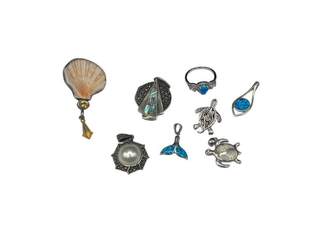 STERLING SILVER OCEAN AND SEALIFE THEMED JEWELRY INCLUDING OPALITE, ABALONE, AND PEARL: INCLUDES MARCASITE AND PEARL PENDANT, ABALONE AND MARCASITE LOCKET, TURTLE PENDANT, SIGNED "SCW" PIN WITH SHELL, AND SEVERAL PIECES WITH INLAID OPALITE 37.03 GRAMS