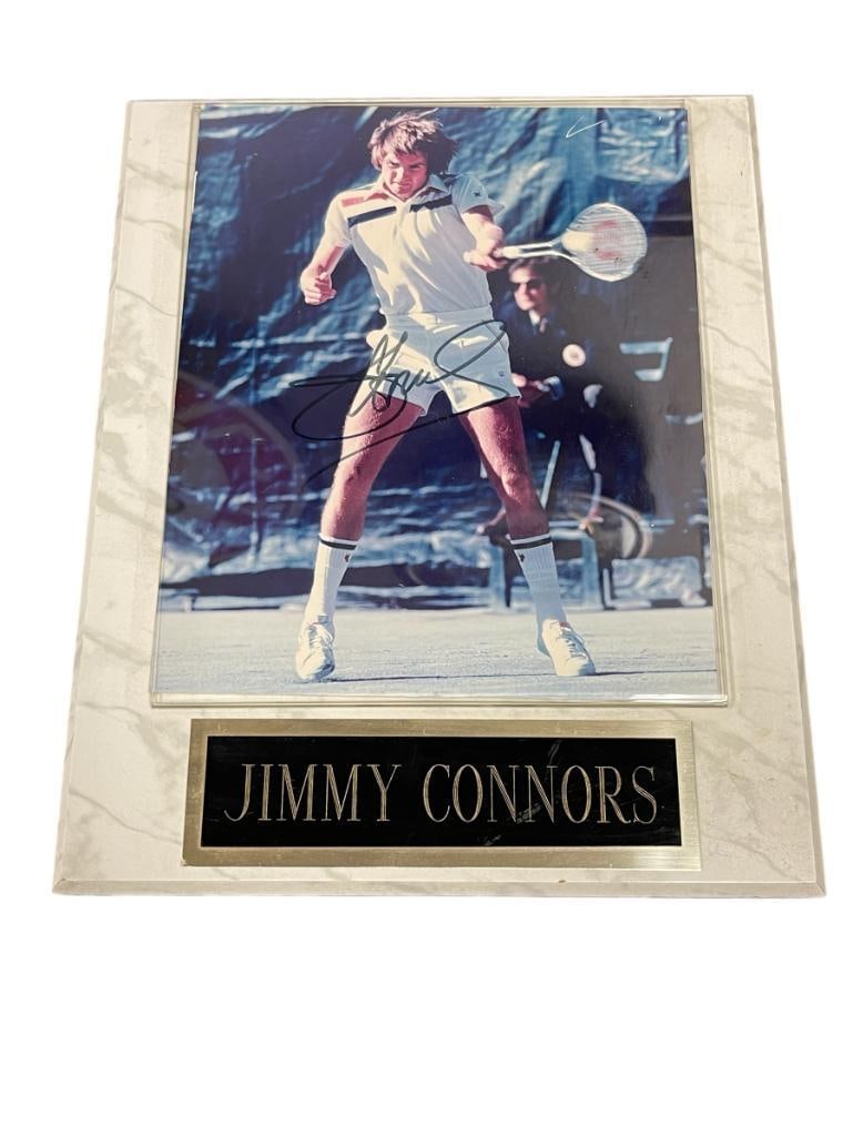 AUTOGRAPHED JIMMY CONNORS PHOTOGRAPH SPORT PLAQUE: JIMMY CNNOR WAS A FORMER PROFESSIONAL TENNIS PLAYER CONSIDERED ONE OF THE GREATEST OF ALL TIME, HELD NO. 1 RANKING FOR 268 WEEKS, PLAQUE FEATURES SIGNED PHOTOGRAPH AND ENGRAVED NAME PLATE 10 1/2"