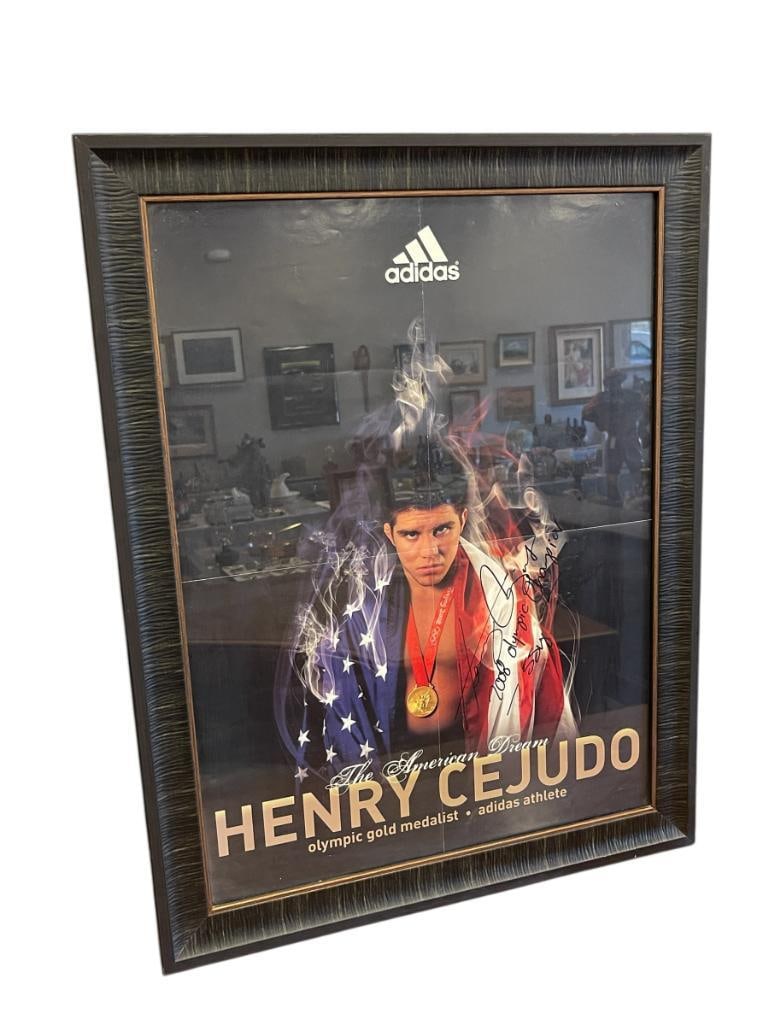 AUTOGRPAHED HENRY CEJUDO MIXED MARTIAL ARTIST OLYMPIC GOLD MEDALIST ADIDAS PROMOTIONAL POSTER: YOUNGEST AMERICAN WRESTLER TO WIN THE OLYMPIC GOLD MEDAL IN 2008 BEIJING OLYMPICS, POSTER SHOWS CREASES FROM STORAGE, FRAMED 21" X 27"