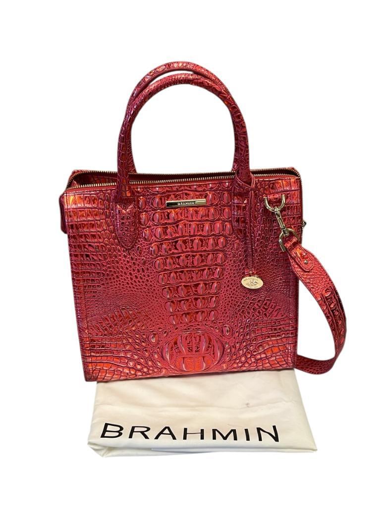 BRAHMIN CAROLINE SATCHED RED DRAGON MELBOURNE ALLIGATOR GRAIN: VIBRANT METALLIC RED / PINK HUE OFTEN CALLED RED DRAGON, FEATURES POLISHED BRASS HARDWARE, BROWN LINED INTERIOR WITH POCKETS AND SHOULDER STRAP, INCLUDES TWO BRAHMIN DUST COVERS, NO MAJOR WEAR 