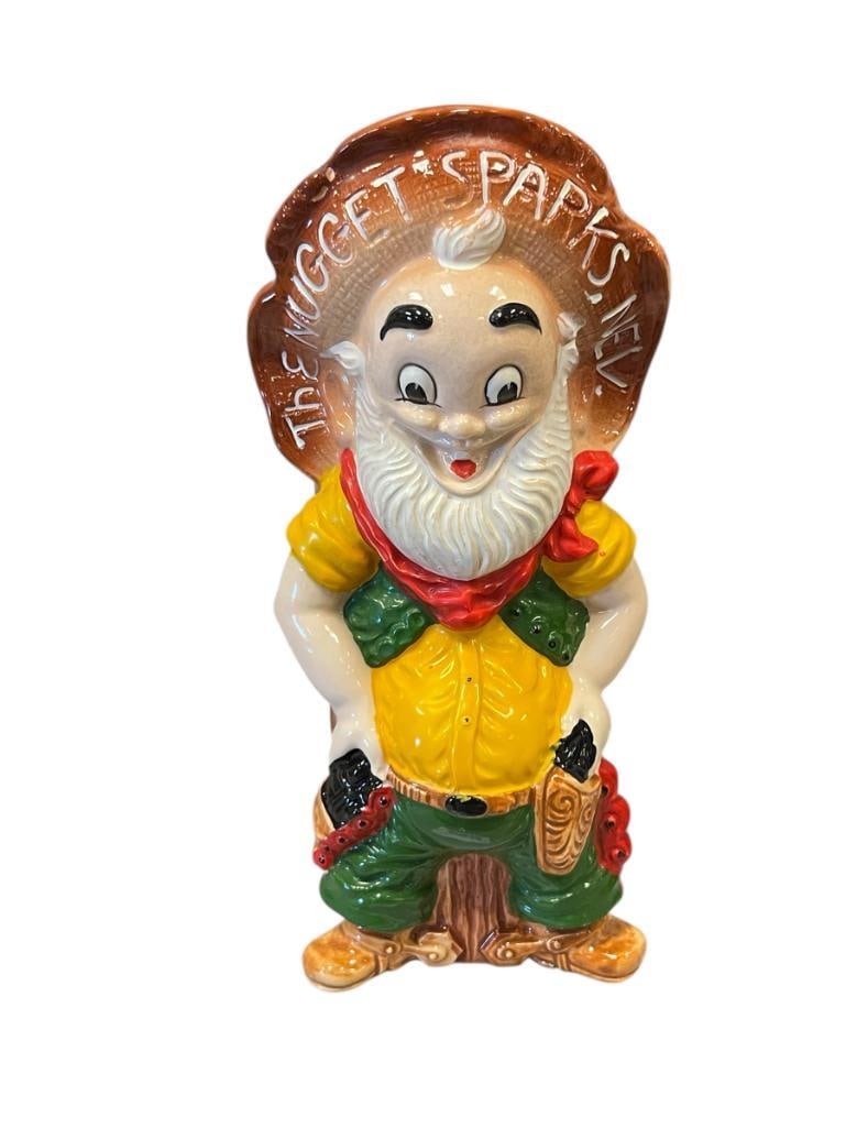 CAMEO COLLECTORS SERIES JOHN ASCUAGU'S NUGGET CASINO SPARKS, NV PROSPECTOR WHISKEY BOTTLE: CERAMIC FIGURAL DECANTER WITH PLASTIC TOP, ORIGINAL LABEL PRESENT 10 1/4" H
