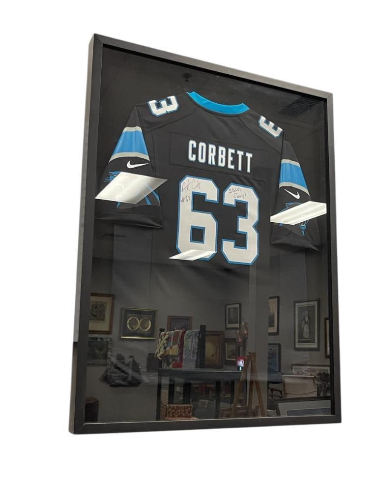 AUSTIN CORBETT SUPERBOWL SBLVI CHAMPION PANTHERS AUTOGRAPHED JERSEY #63: AUSTIN CORBETT WENT TO REED HIGH SCHOOL IN SPARKS, NV, PLAYED UNIVERSITY OF NEVADA AS A WALK-ON, 2018 2ND ROUND PICK, JERSEY IS FRAMED IN A LARGE ALL BLACK SHADOW BOX 31 1/2" X 41 1/2" 