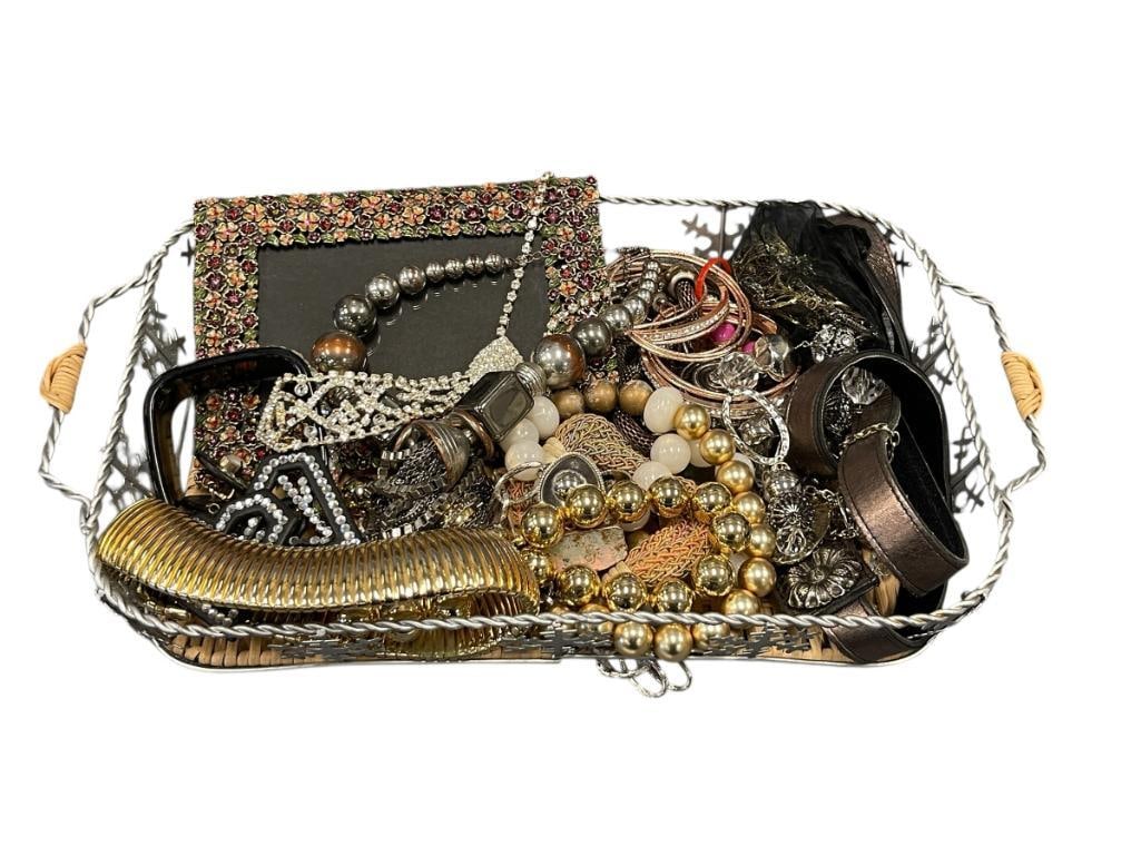 ASSORTED WOMANS FASHION JEWELERY AND ACCESSORIES: INCLUDES RHINESTONE PICTURE FRAME, BELT, CLIP-ON EARRINGS, BRACELETS, NECKLACES, AND MORE, BASKET INCLUDED BASKET MEASURES 14" X 9" 