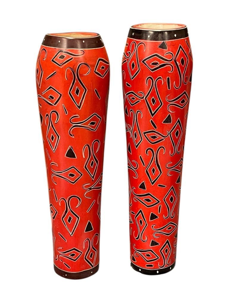 KENYA, AFRICA HAND CARVED HEAVY SOAPSTONE TALL VASES WITH UNIQUE MOTIF: RED AND BLACK DESIGN WITH DARK RED BANDS ALONG THE BASE AND RIM, ONE VASE DOES HAVE A SMALL CHIP ALONG THE BOTTOM EDGE 12 1/2" H 