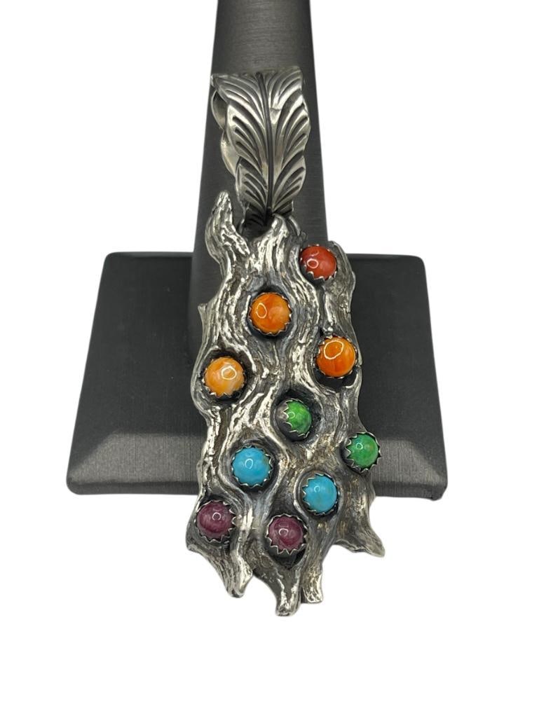 VNITAGE NAVAJO ARTIST SIGNED B. BEGAY STERLING SILVER SPINY OYSTER AND MULTI-STONE TREE BARK PEND...: SIGNED BY ARTIST "B. BEGAY," BELIEVED TO BE BOBBY BEGAY, PENDANT FEATURES A PIECE OF TREE BARK EMBEDDED WITH STONES INCLUDING TURQUOISE, SPINY OYSTER, SUGILITE, AND MORE 2 7/8", 33.80 GRAMS 